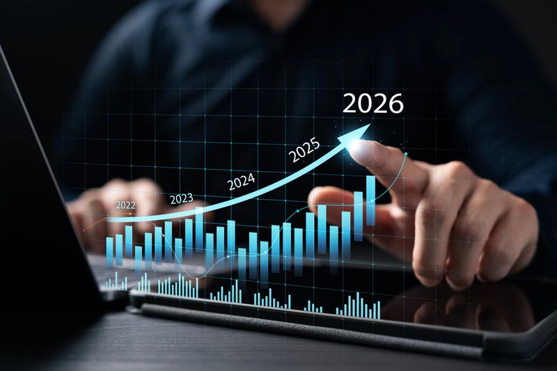New Business Plan Setting Goals for the New Year 2026, businessman using laptop and tablet to strategize and develop the organization to grow to success in 2026, finding business opportunities.