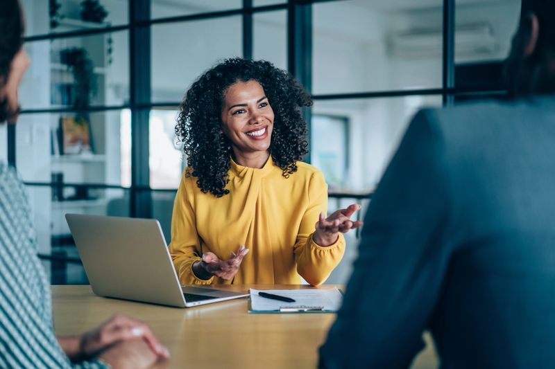 Shot of group of business persons in business meeting. Three entrepreneurs on meeting in board room. Creative business team on meeting in modern office. Female manager discussing new project with her colleagues. Company owner on a meeting with two of her employees in her office.