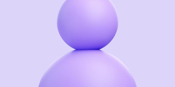 Two smooth purple spheres stacked against a light purple background.