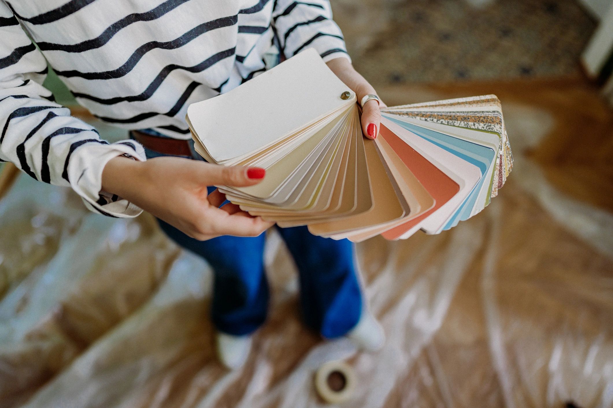 Person holding a paint color swatch fan.
