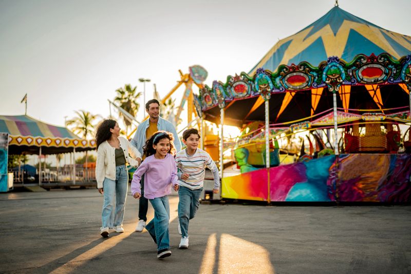 Child siblings running on amusement park
