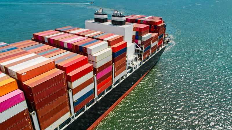 Aerial shot of a container ship arriving in the Port of Long Beach in California on a sunny day. 

Authorization was obtained from the FAA and Port of Long Beach for this operation.