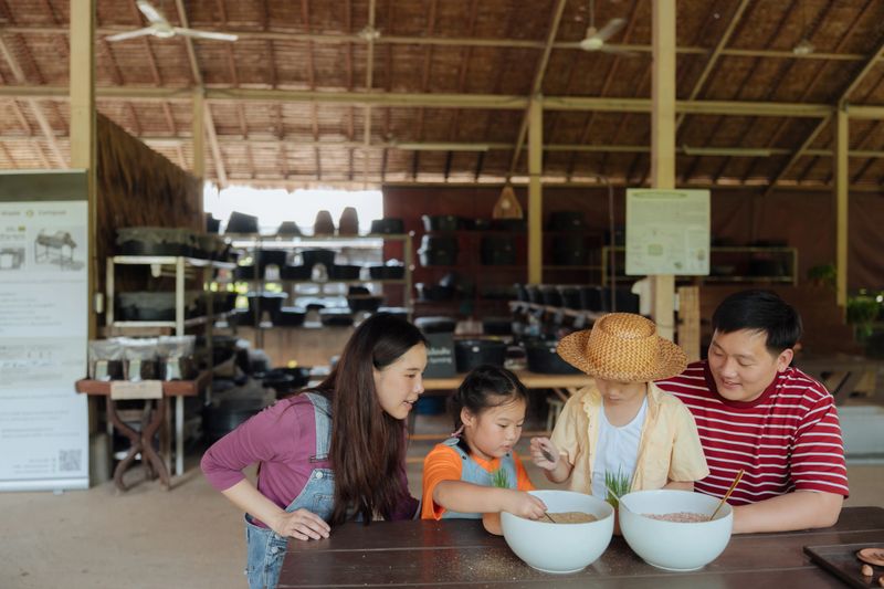 Family volunteers joyfully planting a young tree for a greener environment