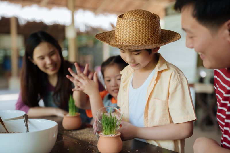 Family volunteers joyfully planting a young tree for a greener environment