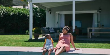 Mother and child sitting by the pool.