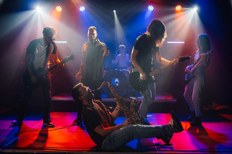 Music band passionately performing their songs during a live concert, creating an electrifying atmosphere