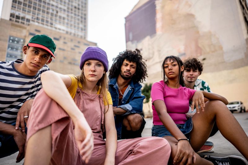 Portrait of young friends outdoors - including a transgender male and a gay man