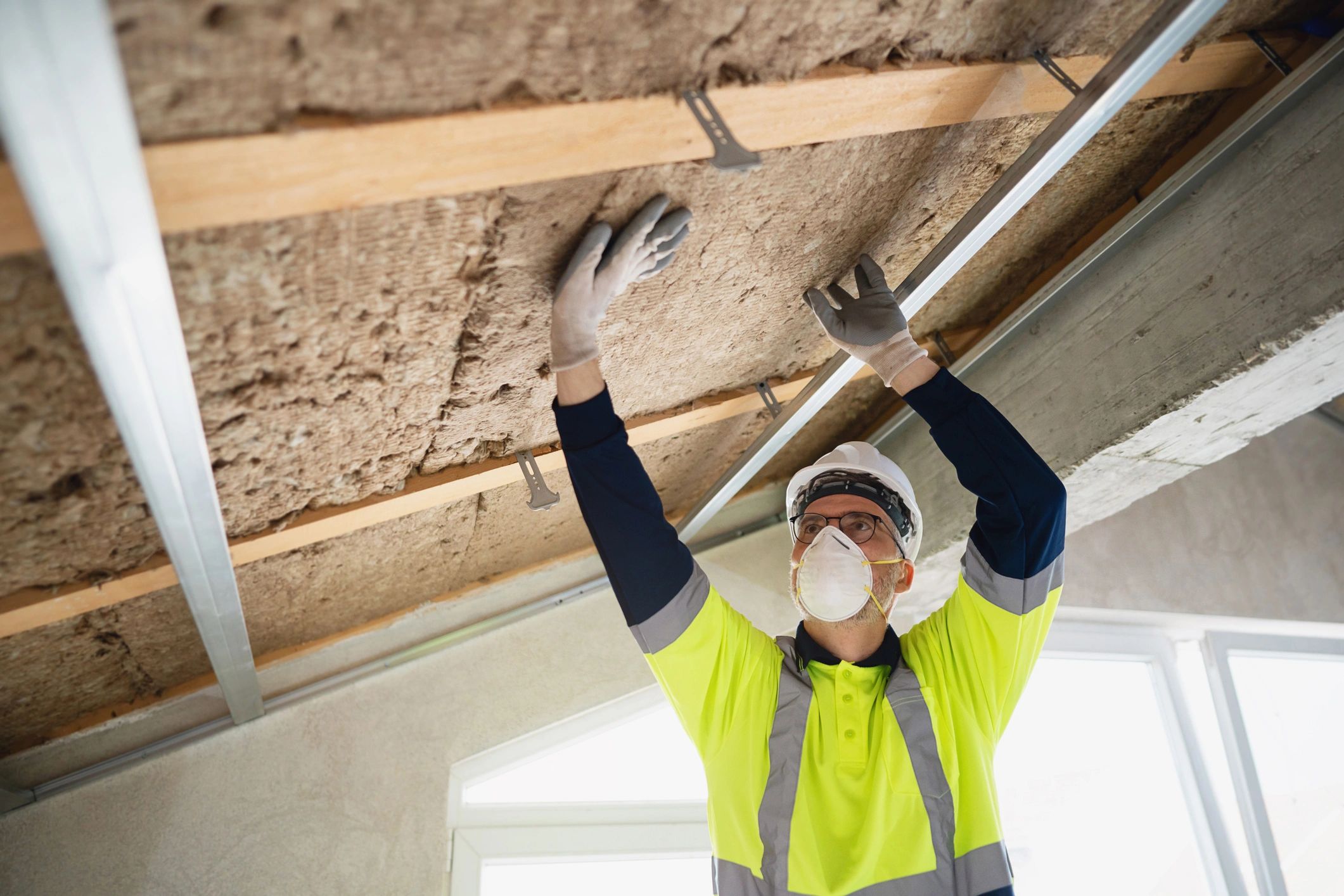 Diagram comparing attic insulation depths and R-values for different home insulation standards.
