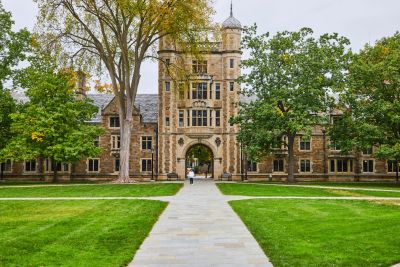 Historic university building with stone pathway.