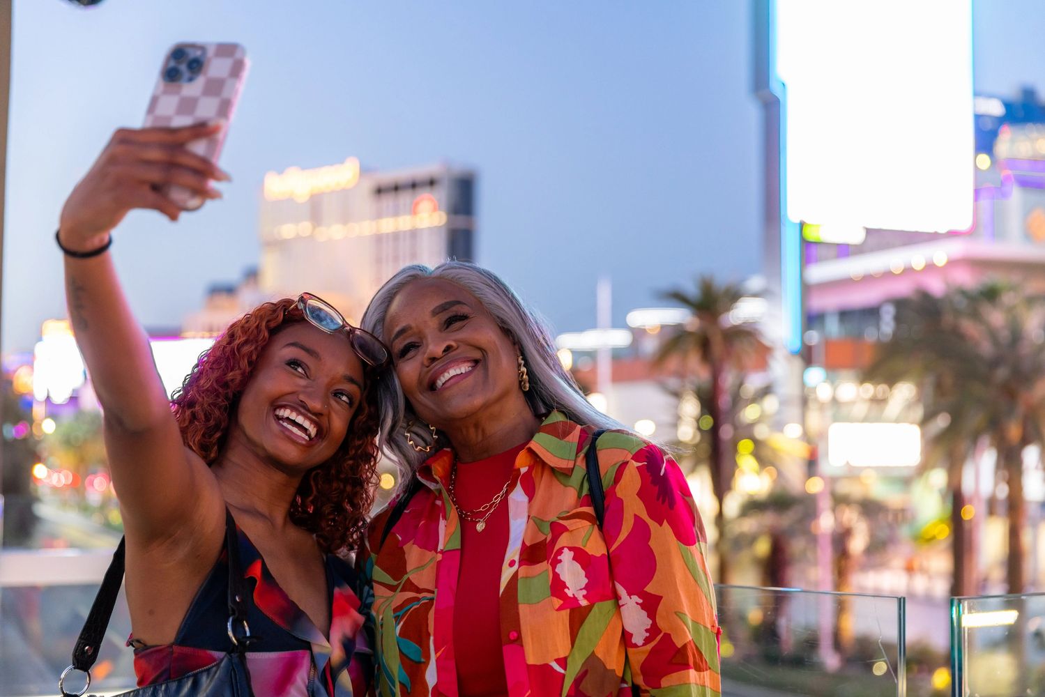 Stack of books next to pencils in a holder and a camera.