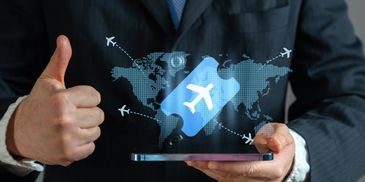 Businessman holding a phone with a digital airplane ticket and thumbs up.