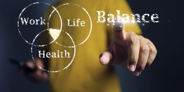 Person pointing at a virtual diagram of work, life, health balance.