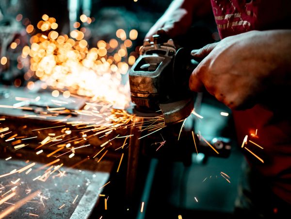 Person using a grinder with sparks flying.