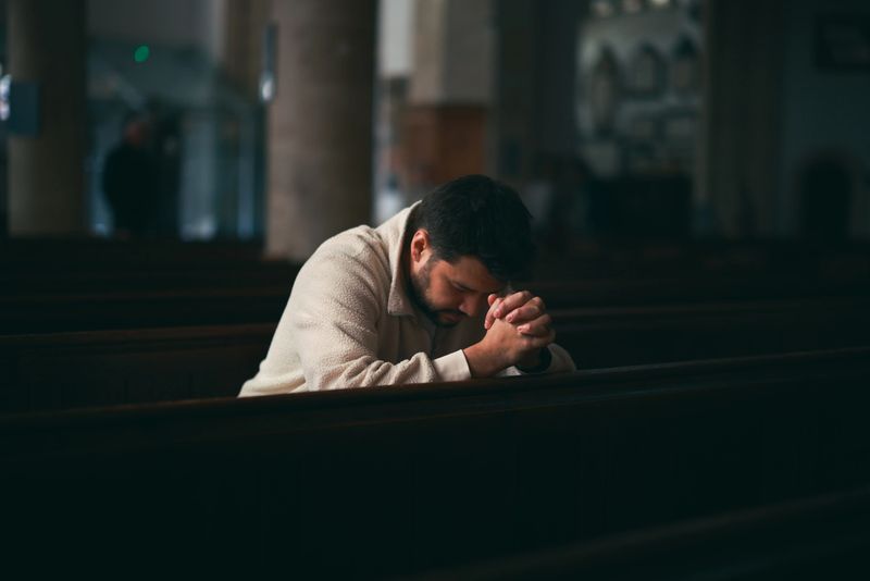 Man worship pray for god blessing to wishing have a better life. Man hands holding praying to god with the bible. christian life crisis prayer to god concept