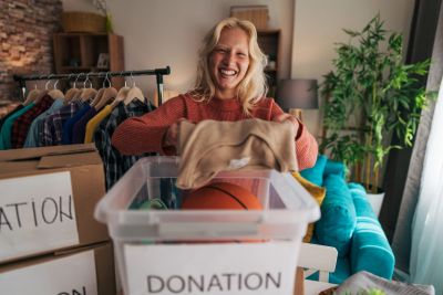 Woman donating clothes and a basketball.