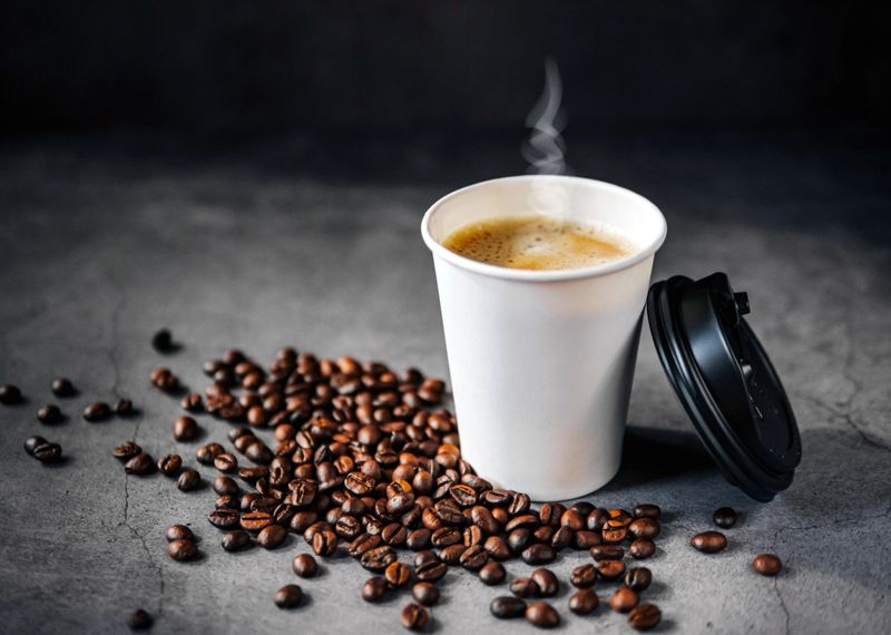 Coffee espresso wite smoke in paper Coffee cup and bean , Fragrant Espresso in  Takeaway paper coffee cup
