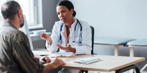 Doctor discussing health with patient.