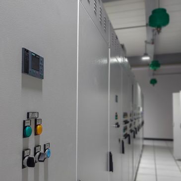 Row of industrial control panels in a clean, well-lit room.