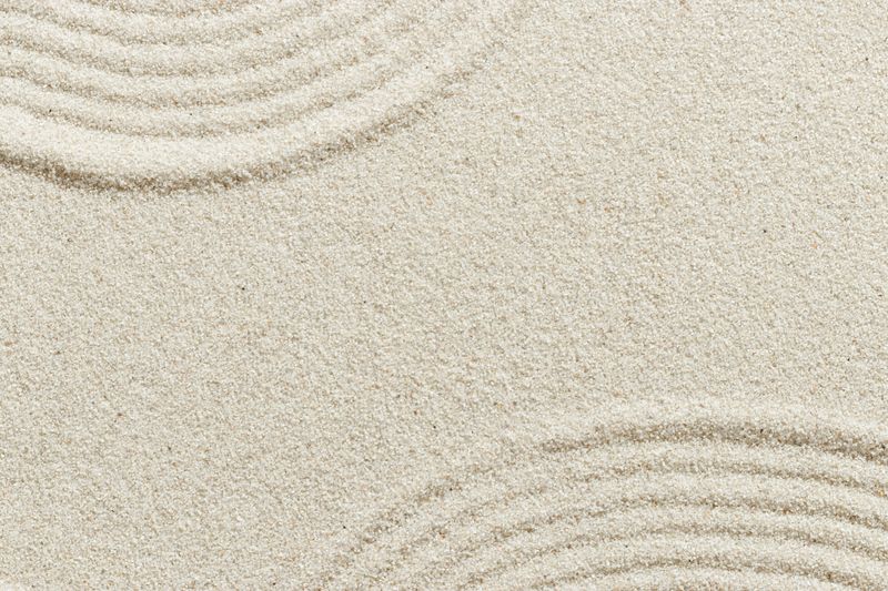 Smooth simple Lines on sand background, minimal aesthetic sandy texture. Spa, meditation, relaxation, wellness concept. Natural beige waves pattern in Japanese zen garden. View from above empty space