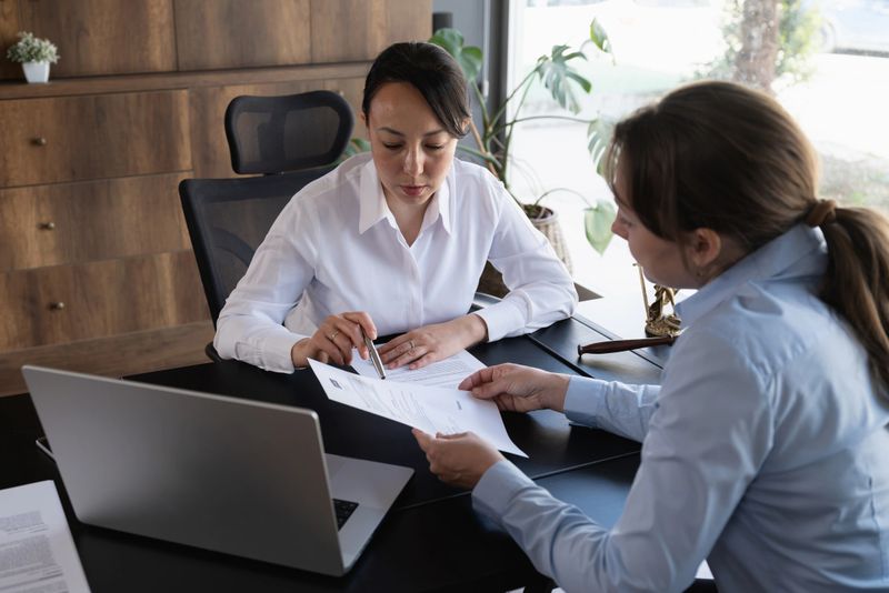 Female legal advisor lawyer helping her client with her legal issues in the office