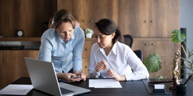 Two women collaborating in an office setting.