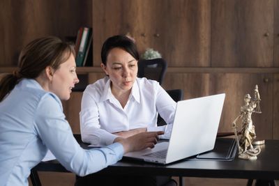 Two business woman and a laptop