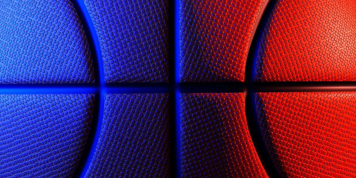 Close-up of a basketball with blue and red lighting.