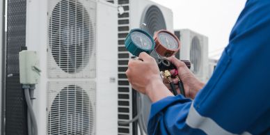 Technician checking air conditioner pressure.