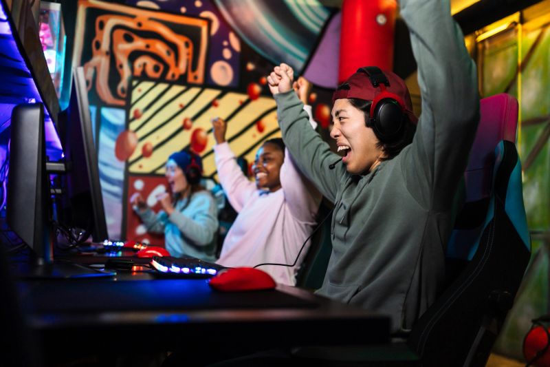 Diverse team of professional players celebrating victory in an exciting video game competition, showcasing teamwork and skill in cybersport