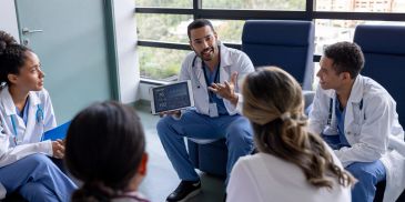 Doctors having a discussion in a hospital room.