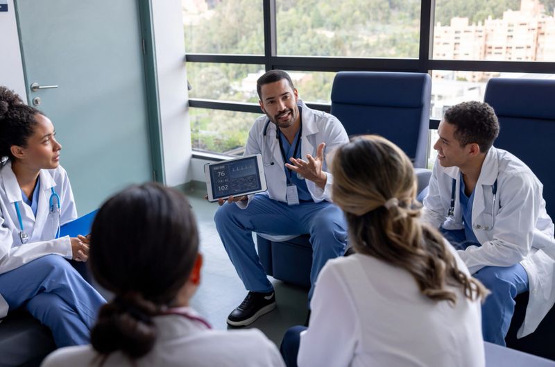 Group of Latin American doctors discussing a case in a meeting at the hospital - healthcare and medicine concepts