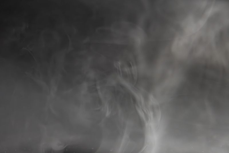 An intense, smokysteamy indoor scene with a mysterious figure under dramatic lighting, suggesting mystery, tension, or urgency for marketing purposes related to movies, TV series, video games, and e