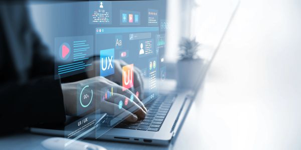 Person working on UI/UX design on a laptop with digital overlays.