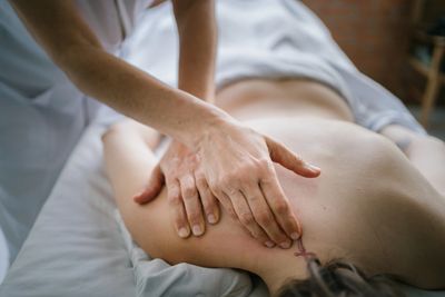 Therapist giving a relaxing back massage to a client.