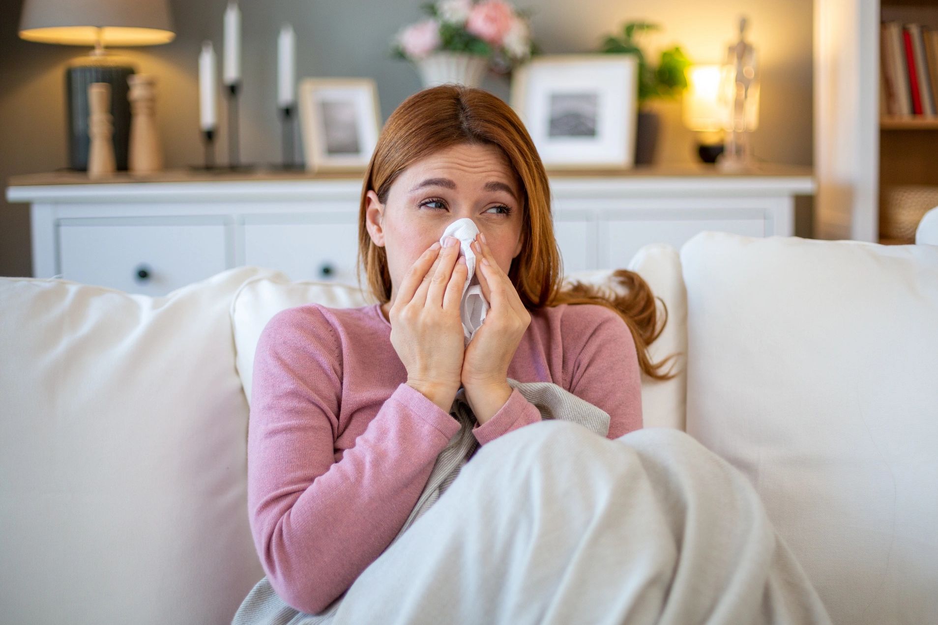 Woman with sinus infection symptoms booking an online medical consult in Montreal.