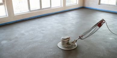 Concrete floor being finished with a power trowel.