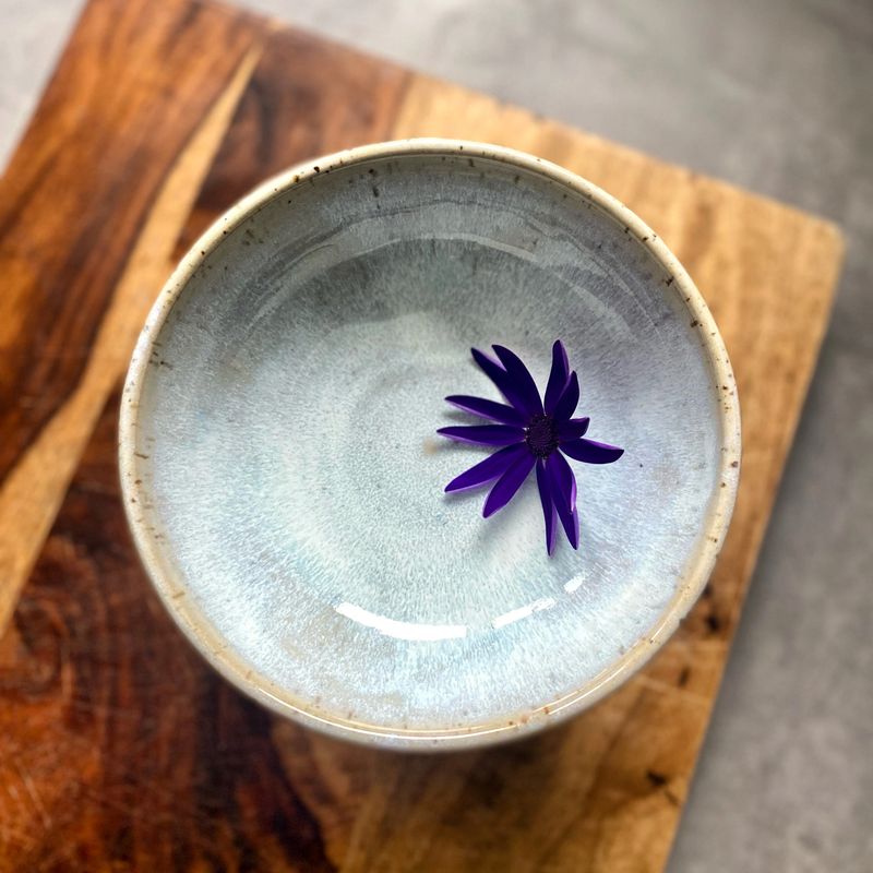 Closeup Handmade Ceramic Bowl on Wooden Board