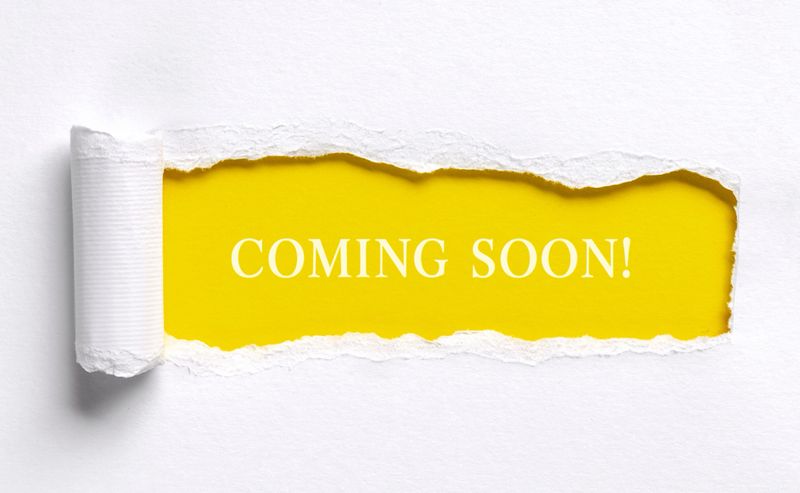 Coming soon text message on yellow background with torn paper edge announcement or promotion concept with copy space
