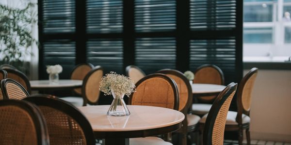 Empty café tables with flower vases.
