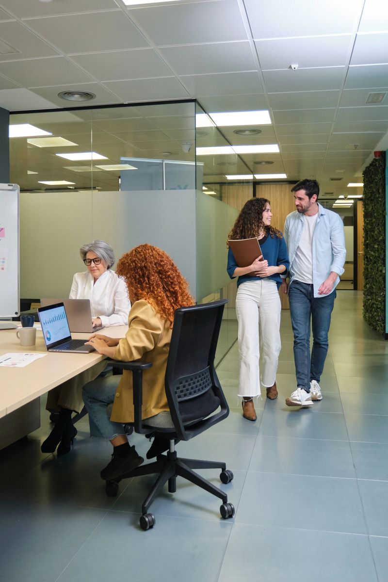 Colleagues collaborating and discussing work in a modern office environment