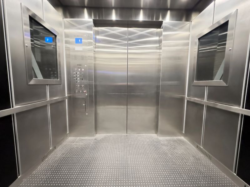Inside view of an empty steel industrial elevator of an office