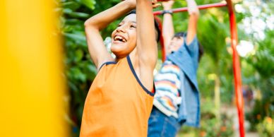 Children playing on monkey bars outdoors.