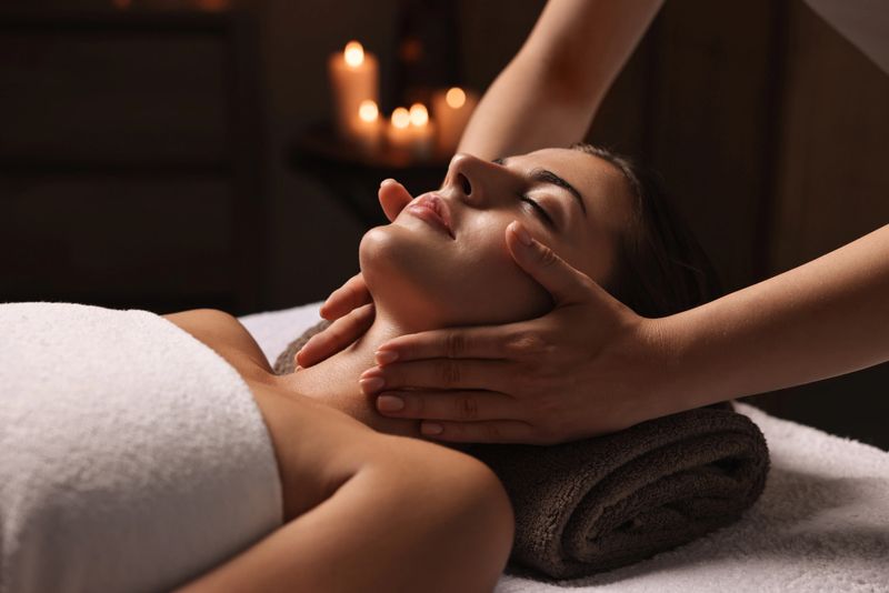 Attractive woman enjoying face massage, closeup. Beauty procedure