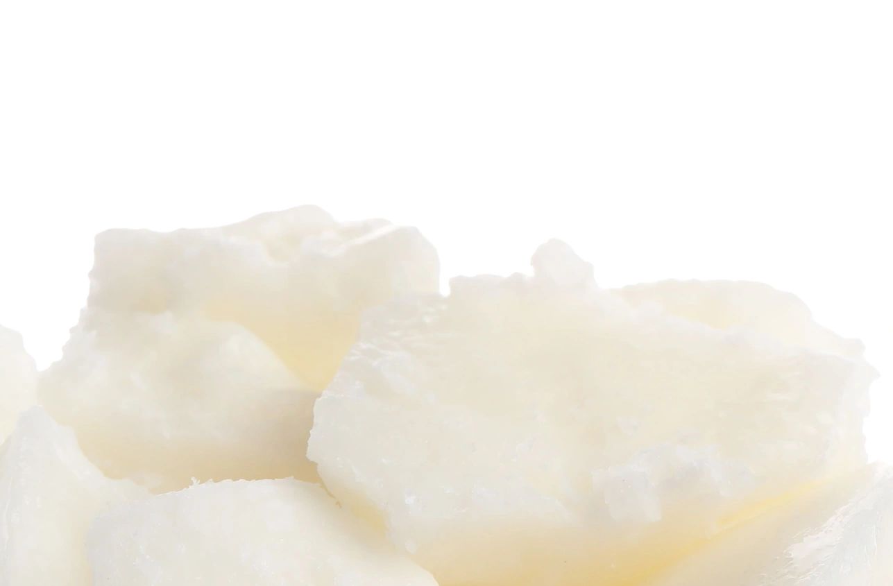 Close-up of solid white chunks on white background.