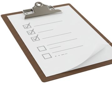 Clipboard with checklist showing some completed tasks.