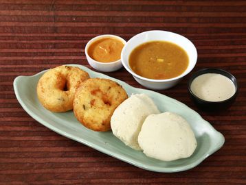 South Indian breakfast with idli, vada, and chutneys.