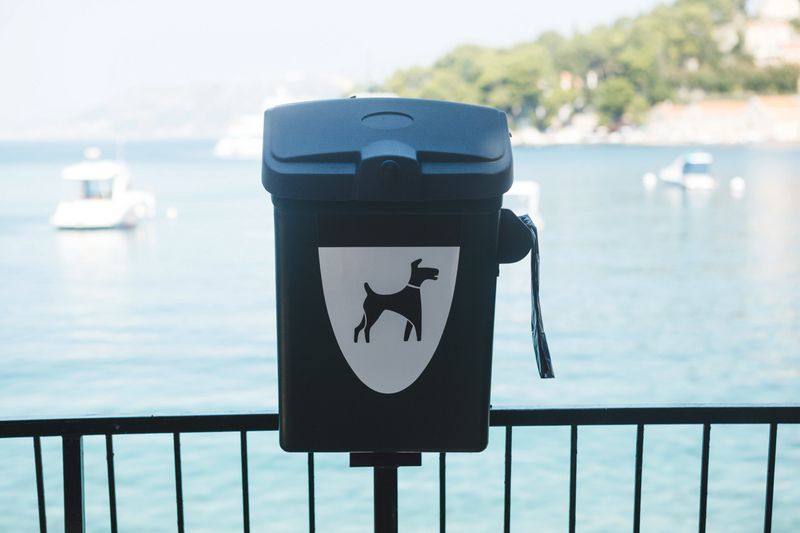 Toilet bags and a container for dog excrement on the seaside of a Croatian resort town