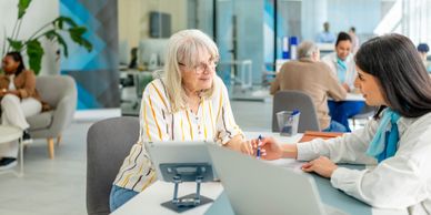 Senior woman consulting with a healthcare professional at a clinic.
