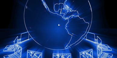 A globe with connected laptops