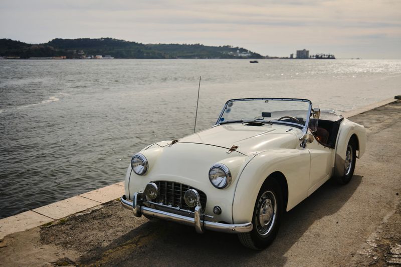Vintage, luxury, convertible car parked on riverbank, Lisbon